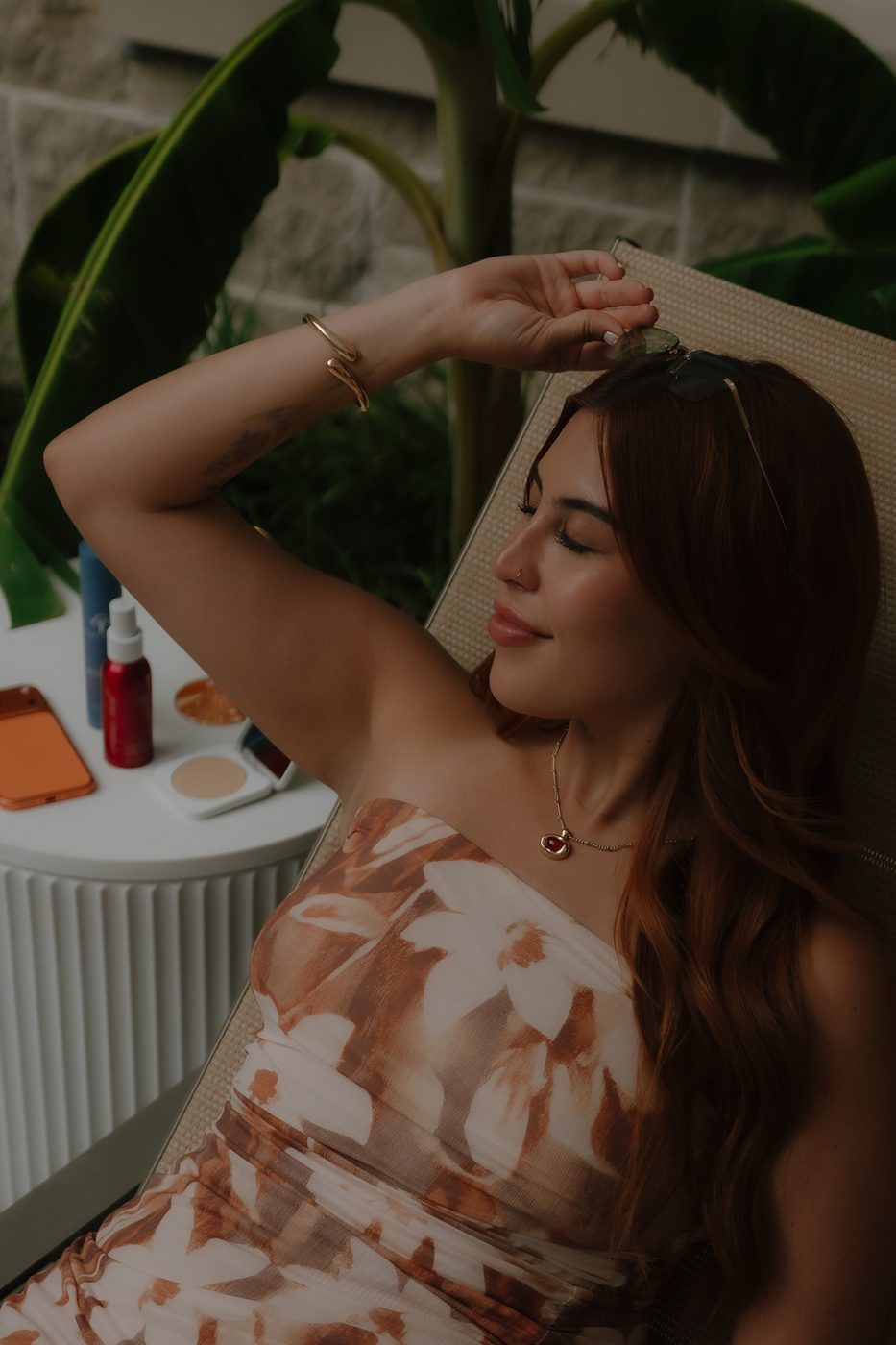 Alexis relaxing poolside with her skincare products during a summer break
