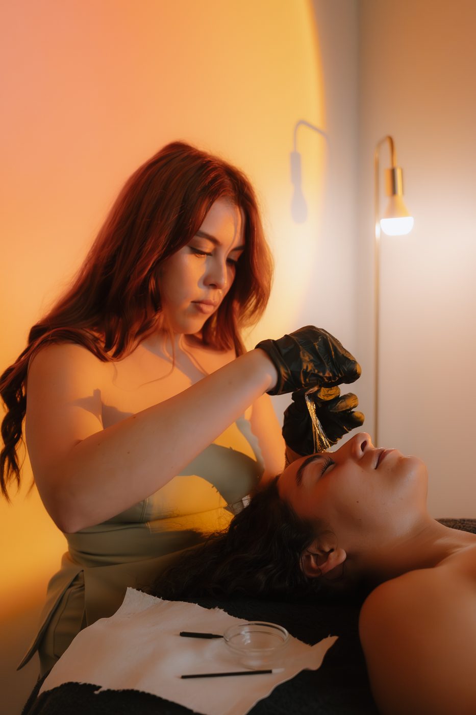 Alexis applying brow tint at Aura Aesthetics
