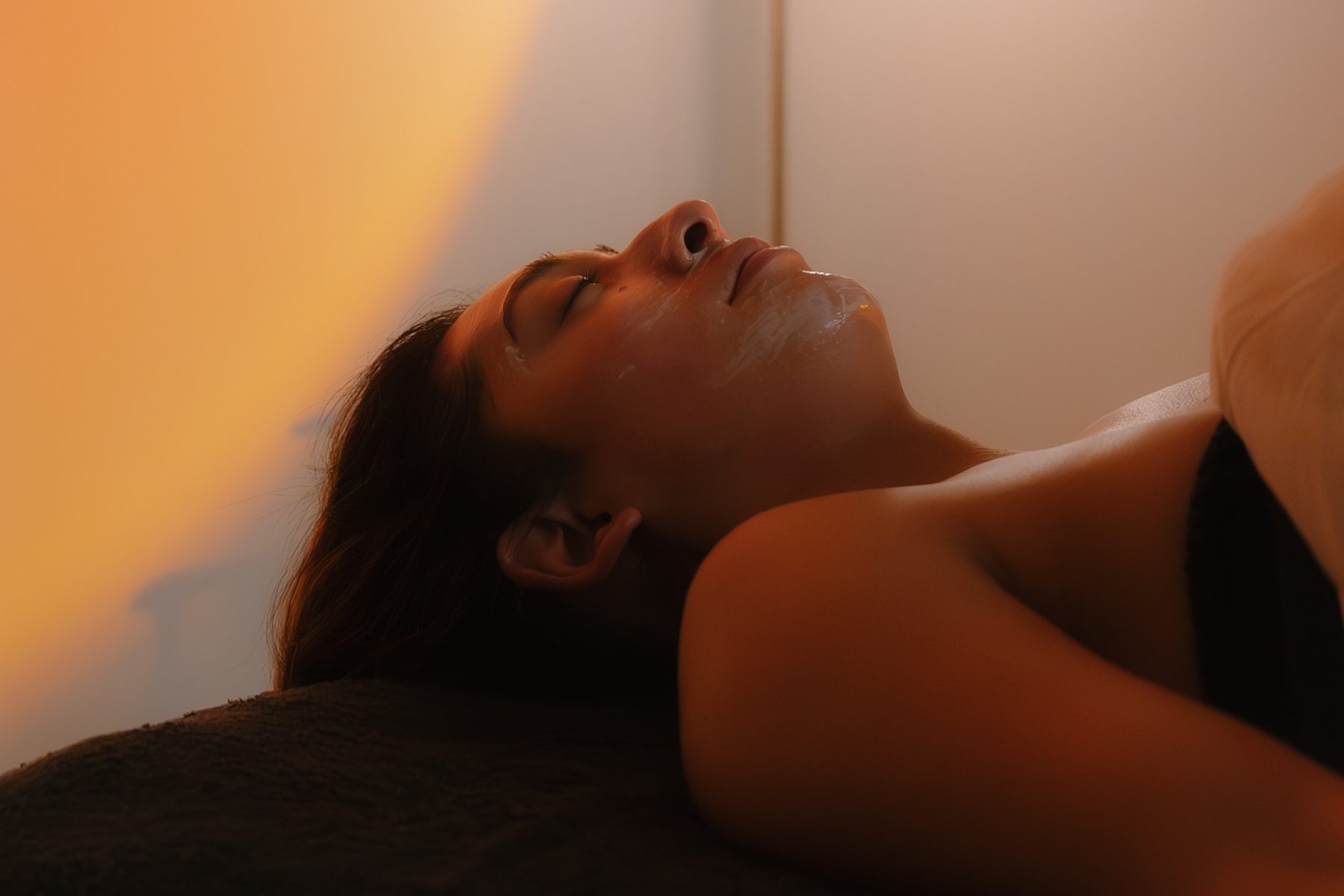 Client relaxing during a facial treatment